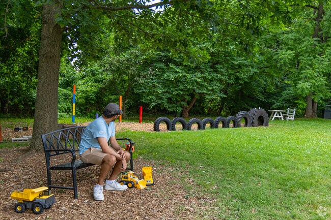 Westgate Park is a small green space with fun amenities like lined up tires and toy trucks.