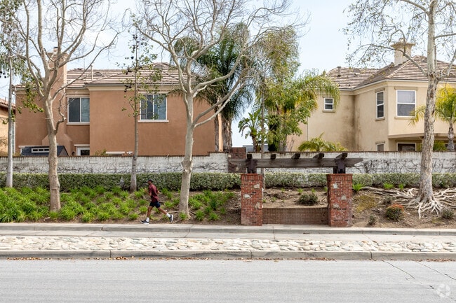 A person jogging on a street in front of Hunter's Ridge Park.