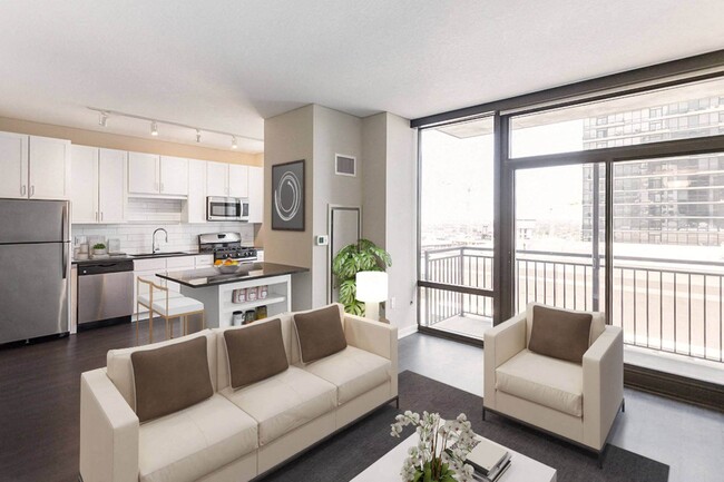 Nic on 5th Apartments in Minneapolis, Minnesota- Open concept living room and kitchen area with floor to ceiling windows