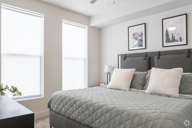 Primary bedroom features windows with retractable shades