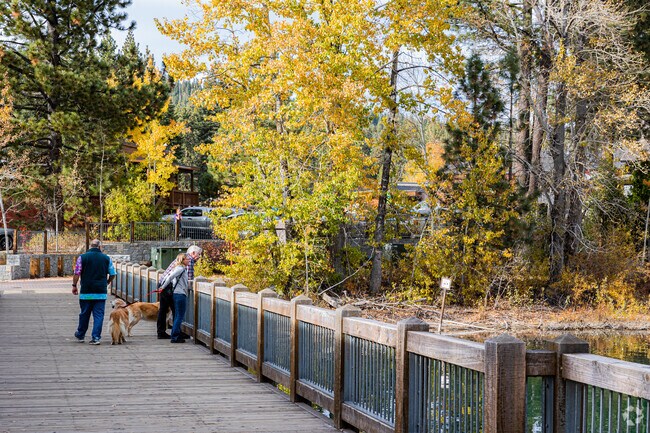 A couple sits and enjoys Lake Tahoe from atop Tahoe City's Dam.