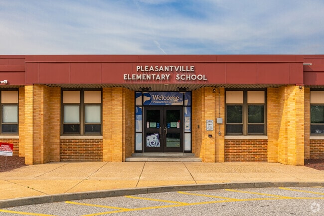 The school mascot, a polar bear, welcomes students into the doors of Pleasantville Elementary.