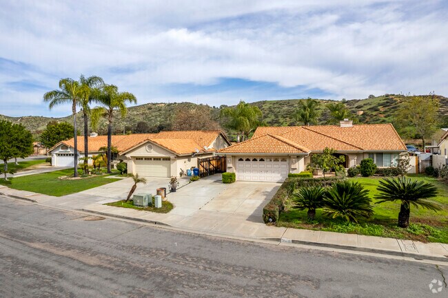 A row of Spanish-Colonials homes under palm trees in Lakeview.