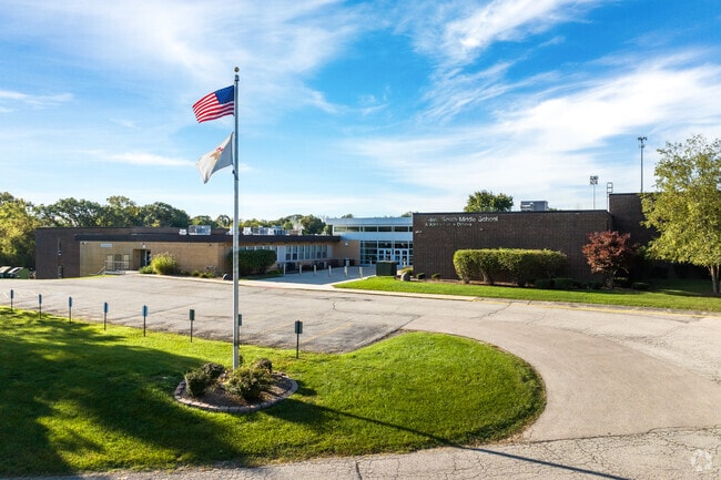 Flags flap in the wind in front of Gavin South Middle School.