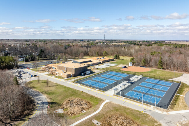 Hemlock Middle School features a large athletics area behind the school for student sports.
