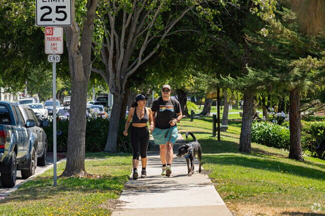 A Billygoat Acres couple starts a morning walk around the park with their furry friend.