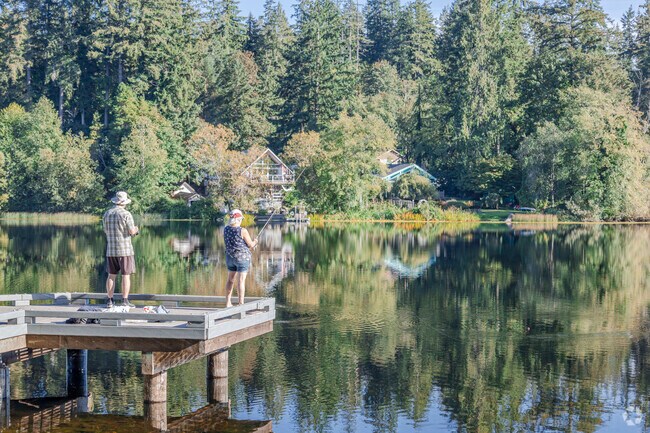 Locals fish from the pier at Island Lake Park in The Summit WA.