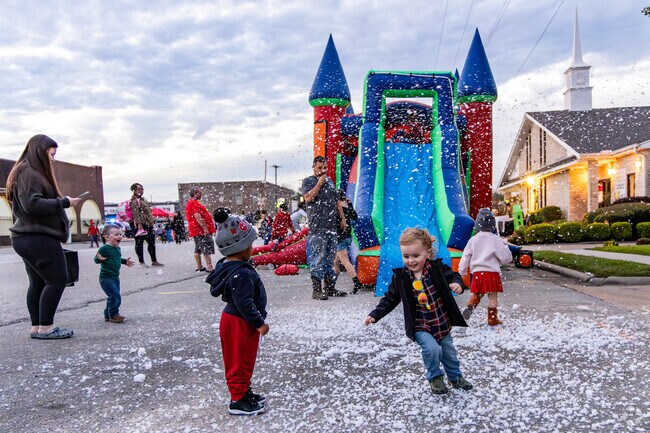 Children enjoy playing in the artificial snow at the Downtown Cocoa Crawl.