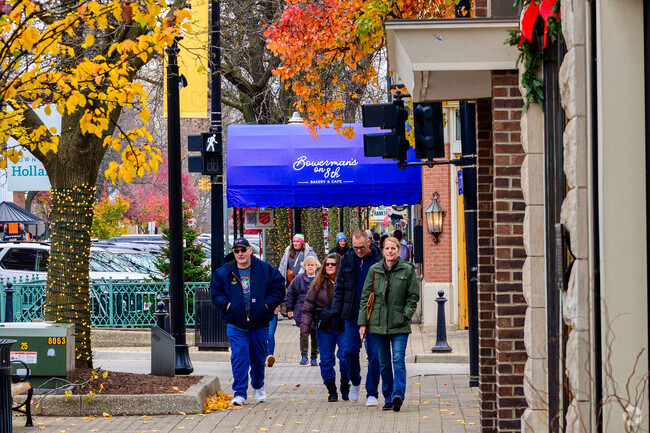 Enjoying the fall weather a family explores 8th St. in downtown Holland.