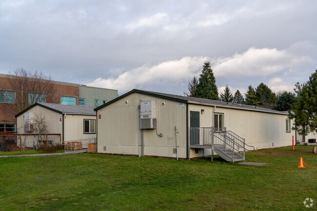 Additional satellite classrooms sit behind the school.