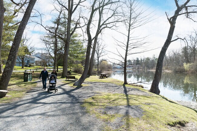 A grandpa and two generations enjoying a walk along Buckingham Pond in Buckingham Lake-Crestwood.