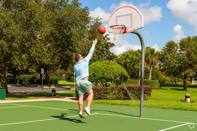 A Live Oak Reserve resident practices basketball for exercise at the neighborhood court.