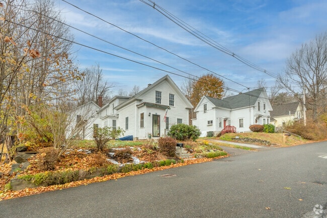 A row of white farmhouse-style homes in Ashburnham.