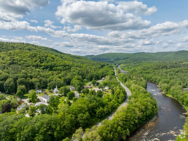 From above, rural Dummerston stretches across forested hills, open farmland, and winding country roads.