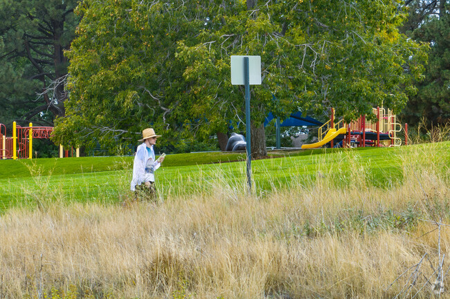 Walk along the paved paths that run through Barnum Park in Denver.