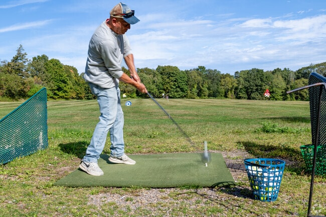 A golfer practices drives at Chanticlair Public Golf Course in Colchester.