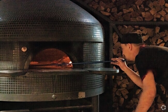 Fresh wood-fired pizza from JJ Hadley is a carefully prepared delicacy near Newburg.
