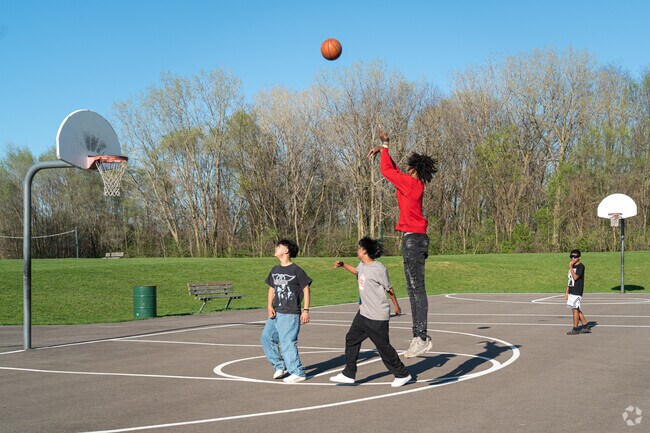 Neighborhood kids join a pickup basketball game at Dr. Martin Luther King Jr. Park in Aurora, IL