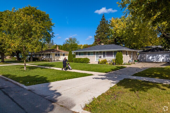 Residents take morning walks along the sidewalk lined streets of Menomonee River Hills.
