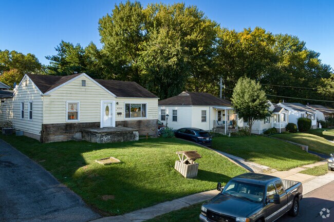 A row of traditional and ranch-style homes on a hill in Woodson Terrace.