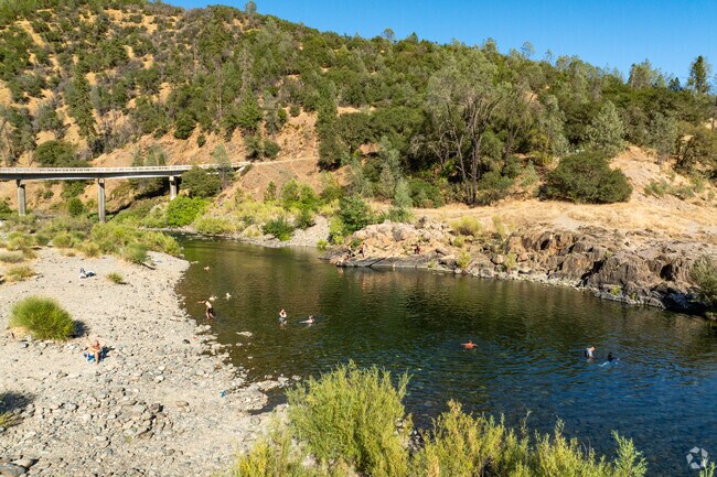 Residents cool off in the American River near Auburn Lake Trails.