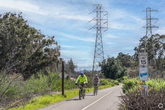 Bikers cruise along the mostly flat trail of Stevens Creek Trail.