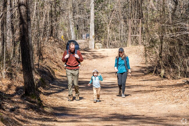 Parents and kids enjoy a quiet walk through Red Mountain Park’s scenic trails.