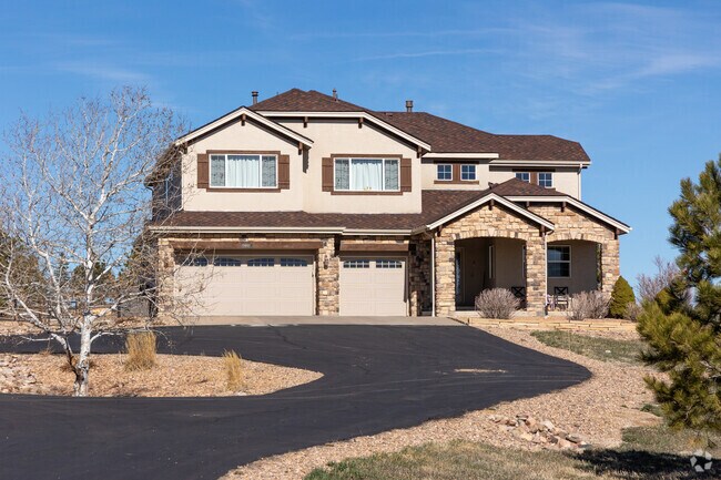 This Elkhorn Ranch home features a pull through driveway and amazing brick work.
