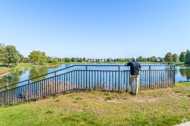 A resident of Lily Cache stops and admires the pond on a sunny day.