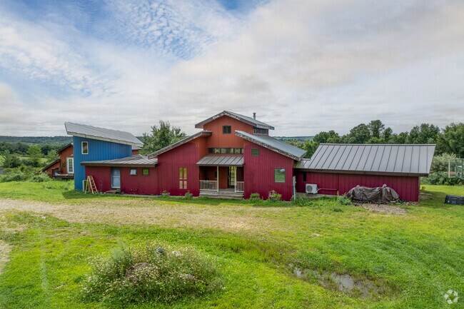 A unique farmhouse in Franklin is red with a blue attachment.
