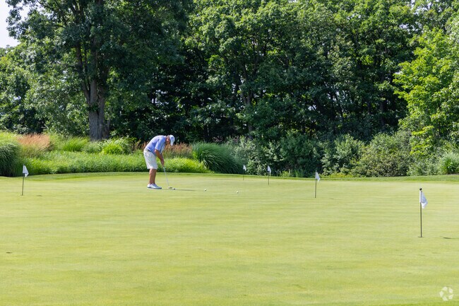 A golfer practices his putting skills at the Burlington Golf Club, a private 18 hole course.