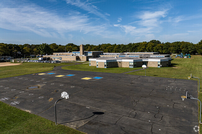 Here is a rear view of the building also showing the basketball court.