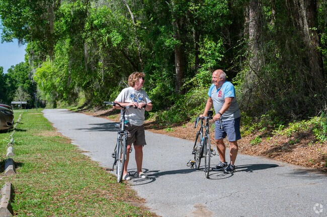 A couple enjoys the Withlacoochee State Trail on a sunny day.