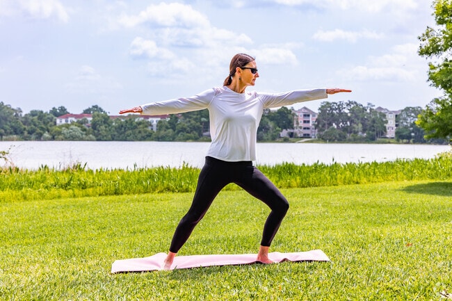 A resident practices yoga  along the shores of Turkey Lake in MetroWest.