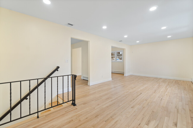 Stair landing with view of kitchen and dining room entrances