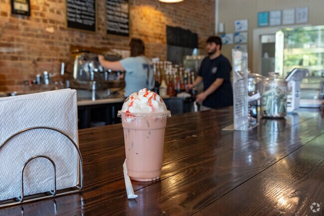 Cole's Coffee & Ice Cream features handcrafted beverages and a warm wooden counter setup.