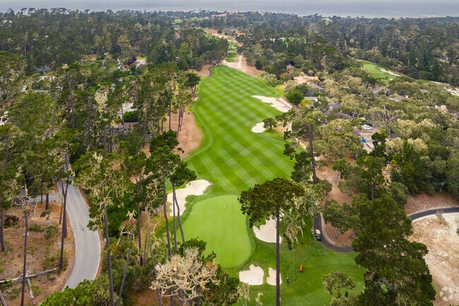 Thick forest meets elite golf experience at Pebble Beach Golf Links in Pebble Beach, California.