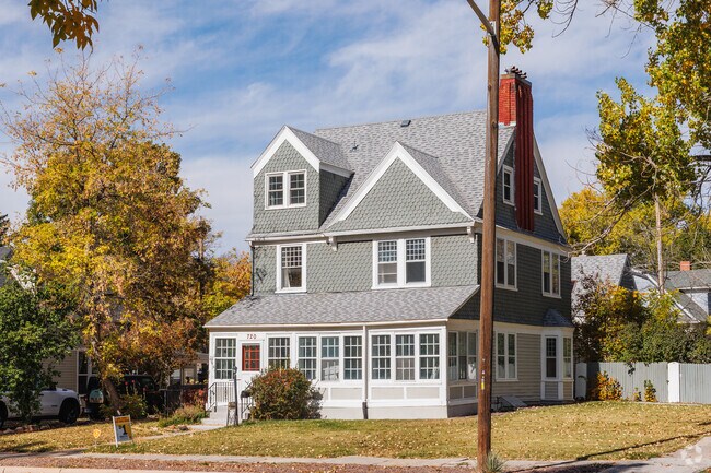 Historic Cheyenne feels suburban, with tall trees, driveways and paved sidewalks.