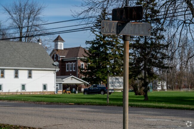 An old street sign in Clifford with the 1912 Schoolhouse, a view seen for many years.