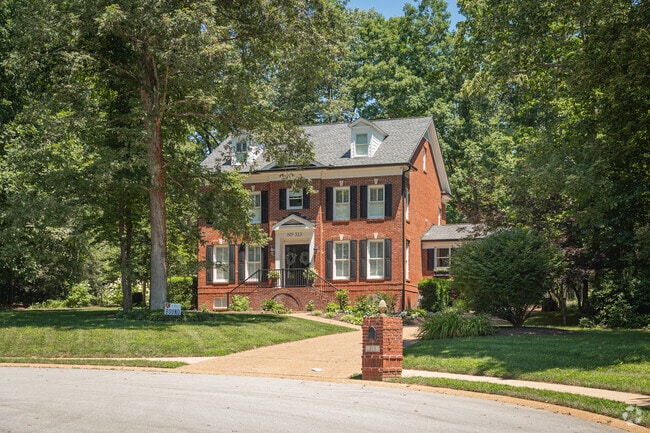 This brick colonial finds purchase on a wooded lot in Walden.