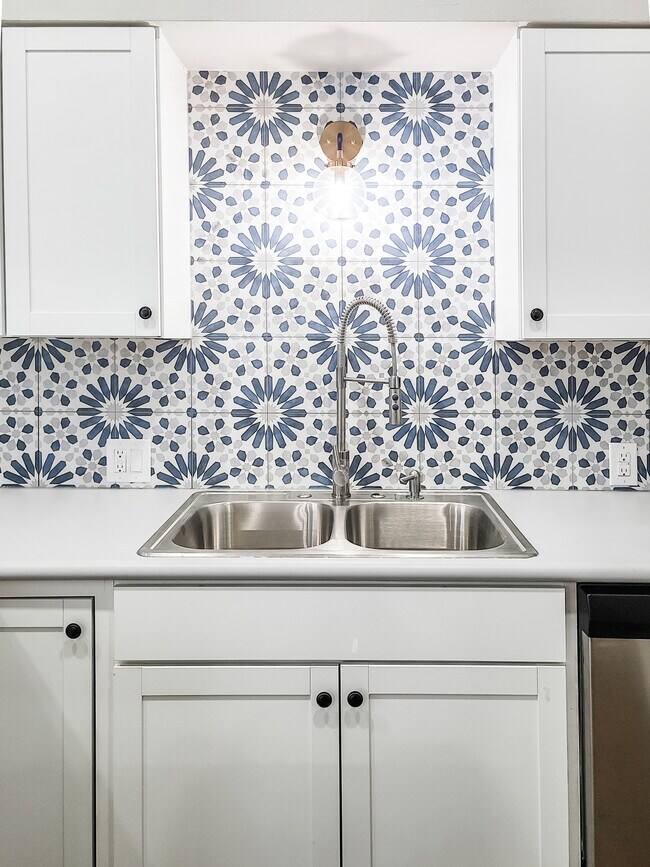 Modern Cabinets, Stainless Steel Sink, Dishwasher and charming backsplash detail