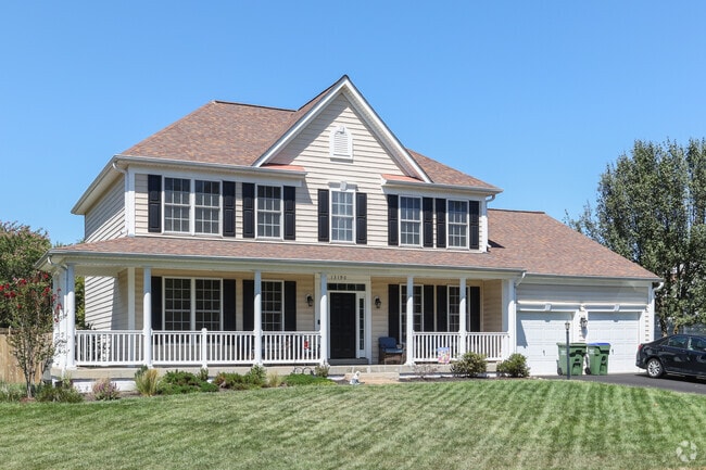 Stately homes with covered front porches and green lawns line Kingsbrooke’s quiet streets.