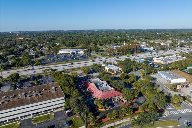 Mature tree cover a small playground at the rear of The Lyman School.