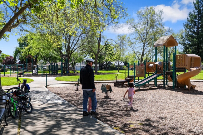 Children laugh and play at the playground in Sacramento’s Tahoe Park South.