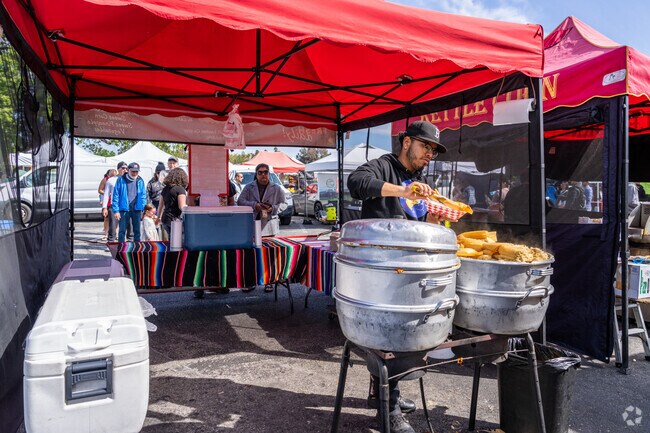 The vendor grabs some hot tamales for his customer at the Santa Clarita Farmer's Market.
