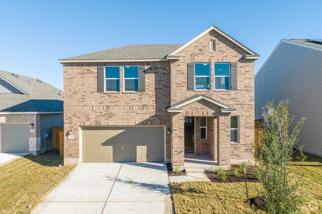 Two-story brick facade home with a newly landscaped yard in Eastwood Community.