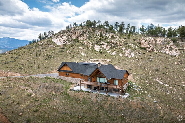 A contemporary mountain home is built on hillside lot in Pine Junction Area.