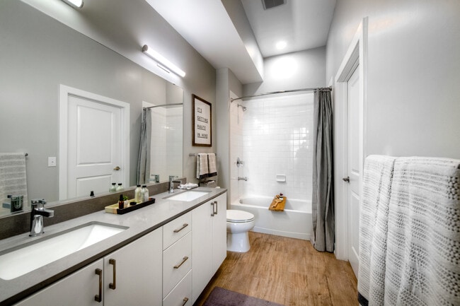 Scheme 1 dual vanity bath with quartz countertop, hard surface flooring and modern fixtures