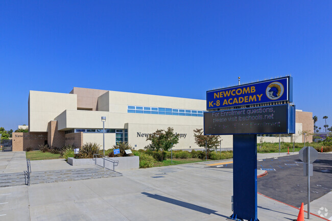 There is a large entrance sign outside of Newcomb Academy.