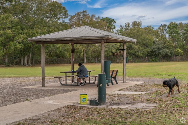 Pinecrest West Park residents hang out at the dog park with their pets.